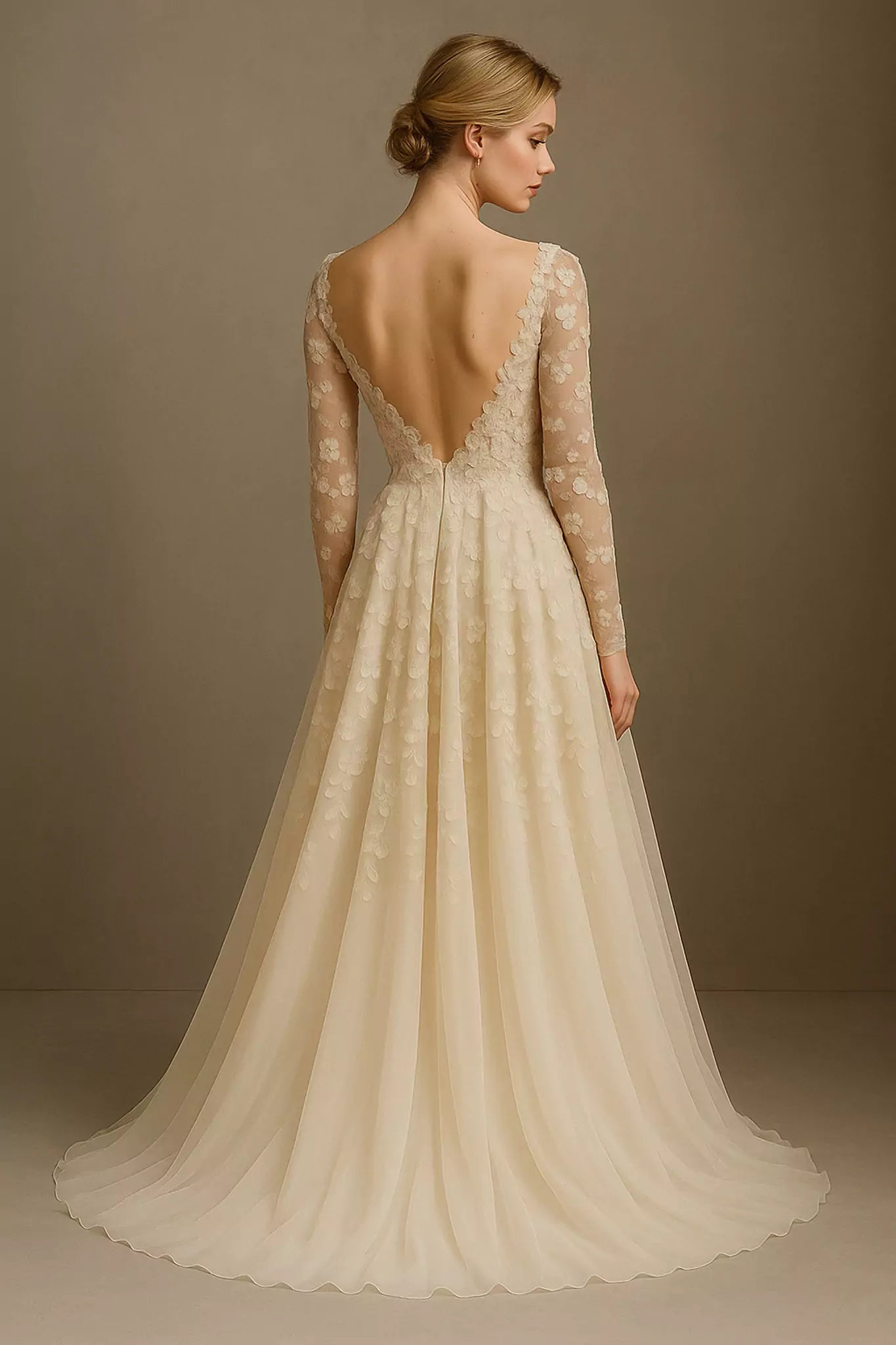 Back view of Cecilia Eleganza bridal gown showing low illusion scoop with covered buttons and soft chiffon train